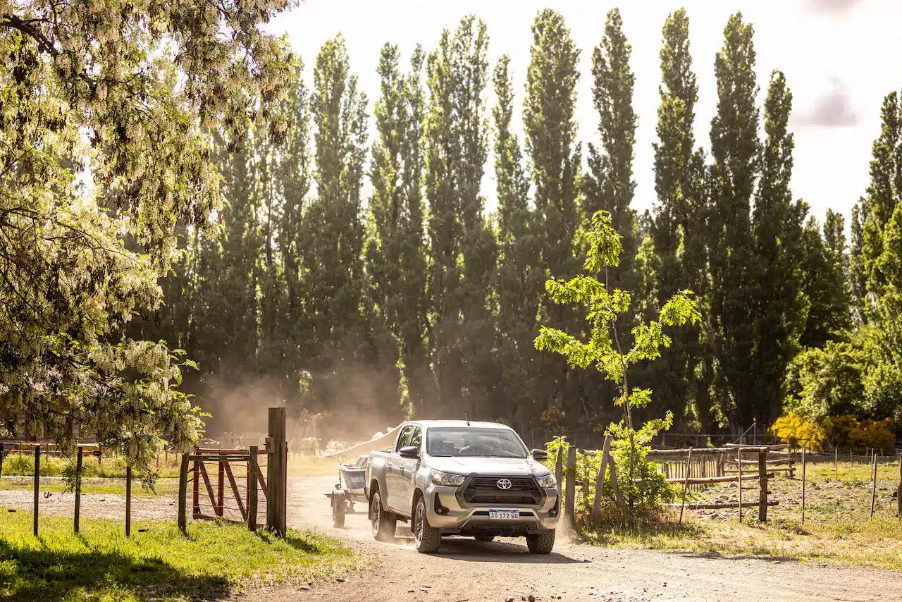 A truck towing a fishing boat drives out of the estancia at Tipiliuke Lodge in Patagonia