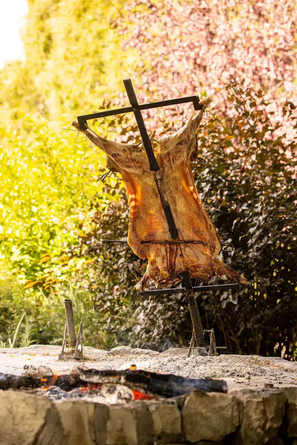 a lamb asado over the fire on a stake at Arroyo Verde lodge Patagonia